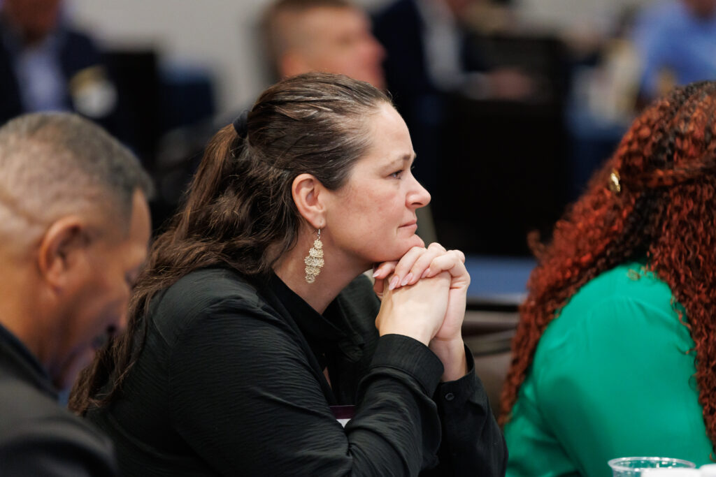 An attendee listening closely during a corporate event session