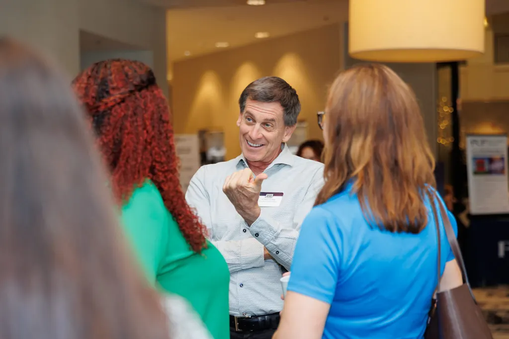 Guests talking at a networking reception in Orlando